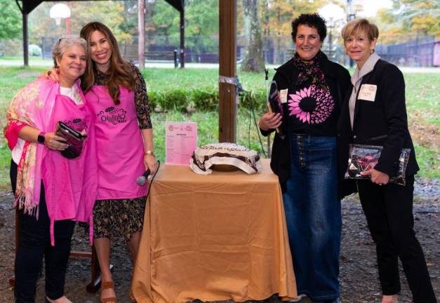 Anita Reich, of Monroe, Chana Burston of Monroe, Janice Spencer of Monroe and Suzy Merin of Goshen pictured at Chabad’s Pink Mega Challah Bake. Chana Burston, director of the Jewish Women’s Circle, presents gifts to event chairs Anita Reich and Suzy Merin, and thanks Suzy Merin and Janice Spencer for sharing stories of strength.