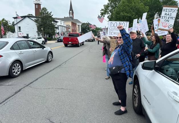 Protesters rally passing cars to honk in Goshen.