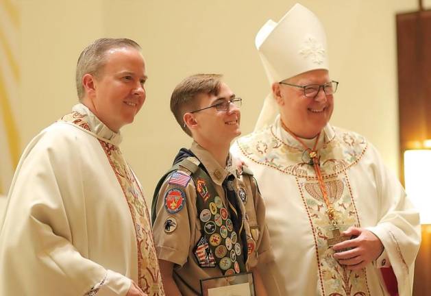 Scout Sean Mende was honored for his leadership work in this effort in relocating the church’s tabernacle to the center of the church altar last Sunday at Sacred Heart Church in Monroe. He is pictured here between the Rev. David Rider, the church’s pastor, Cardinal Timothy Dolan, the Archbishop of New York.