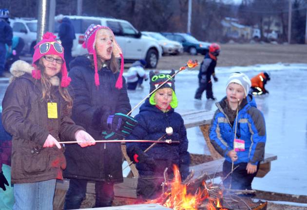These youngsters toast marshmellows over an open fire last Saturday during a bonfire organized by the Town of Tuxedo Recreation Department. From left to right, they are: Natalie Welsh, Marian Welsh, Christopher Ahart and Jameson Brooks.