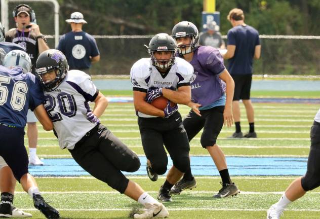 Peter Mastropolo covers the ball as he bursts through a big hole in the John Jay line.
