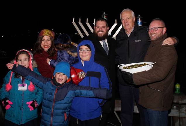 Photos by Dr. Michael Hoffman and Sherri Eccelston Pictured at the Monroe Menorah lighting from right to left are: Monroe Mayor Jim Purcell, Al Muhlrad of Goshen, Rabbi Pesach and Chana Burston, along with some of their children.