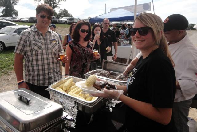 Chumley's BBQ serves up rotisserie chicken, ribs, Pennings' sweet corn and sides for festival participants.