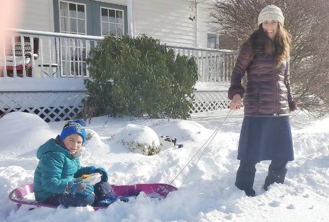 Kovy (5) and Ziggy (9) Burston of Monroe sled through more than two feet of snow to deliver the joy of Hanukkah by bringing sizzling hot latkes to some neighbors on the snowy seventh day of Hanukkah. Chana Burston, along with her husband Rabbi Pesach, direct Chabad of Orange County (www.ChabadOrange.com). Provided photos.