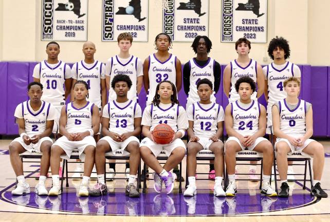 The 2025-2026 Crusader Varsity Basketball Team - seated (from left): Zahir Knight, Jeremy Jimenez, Daniel Omitiran, Jamir Johnson, Marcus Jerome, Christian Pierre and Garrett Rostkowski. Standing (from left): Vodjley Jovial, Kristopher Bjaelker, Luke Postolowski, Dozie Nwigwe, Fabrice Ndja, Charlie Theokas and Alex Diaz.