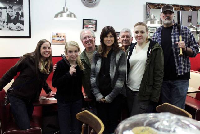Provided phot Script supervisor Jillian Phipps, left, actor Jessica Buck, actor Ken Sharp, Maria Sauer, owner of Maria&iacute;s in Monroe, actor Michael Edan, actor Rebecca Nyahay and actor Gabe Fieramosco share a fun moment before shooting at Maria&iacute;s begins.