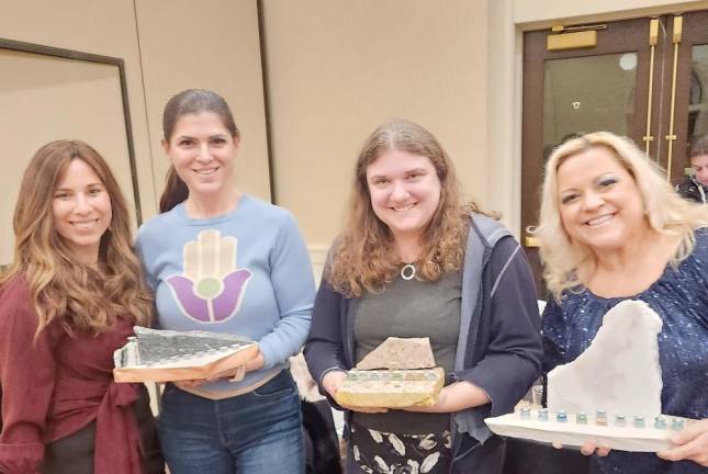 In preparation for Chanukah, the Jewish Women’s Circle gathered at the Chabad Center in Monroe for Menorahs &amp; Martinis. Pictured: Chana Burston, director of Chabad, Corbett Hoffman, of Goshen; Becky Benezra, of Monroe; and Serach Alicia, of Goshen.