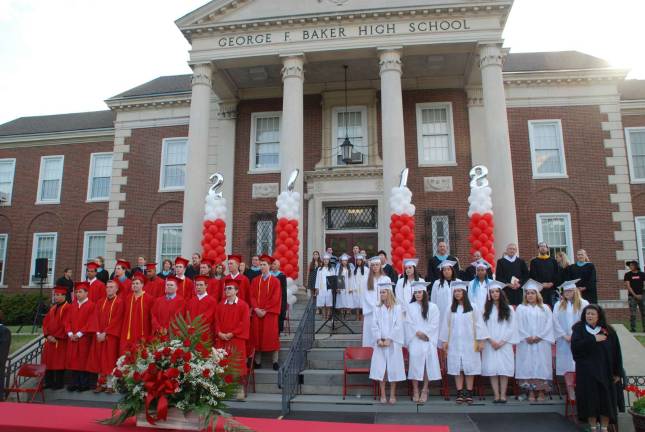 Photos by Ed Bailey The George F. Baker High School Class of 2018 stand with their teachers at the beginning of graduation exercises on June 21.