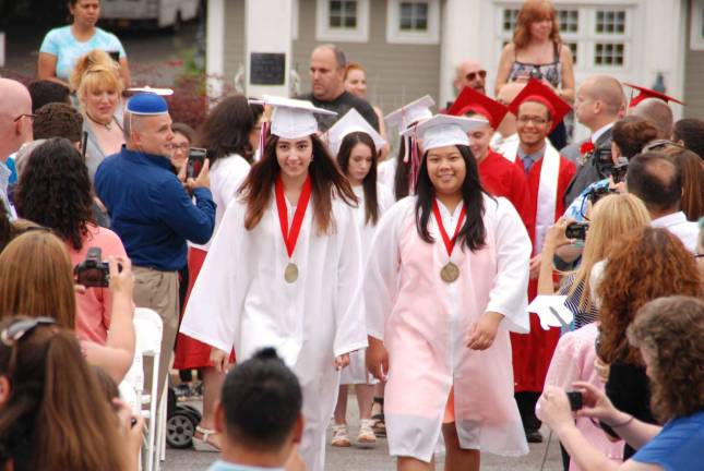 Valedictorian Isabella Zaccardi and Salutatorian Kelly Chhe lead their classmates into the graduation ceremony.