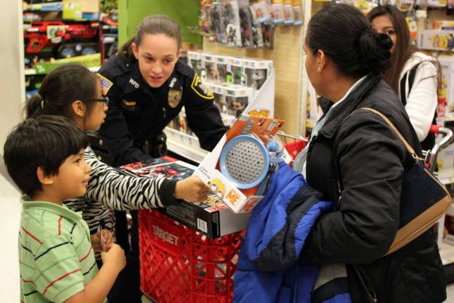 Decisions, decisions: Woodbury Police Officer Kristen Potter helps Juliana and Steven Gonzalez pick out some toys.