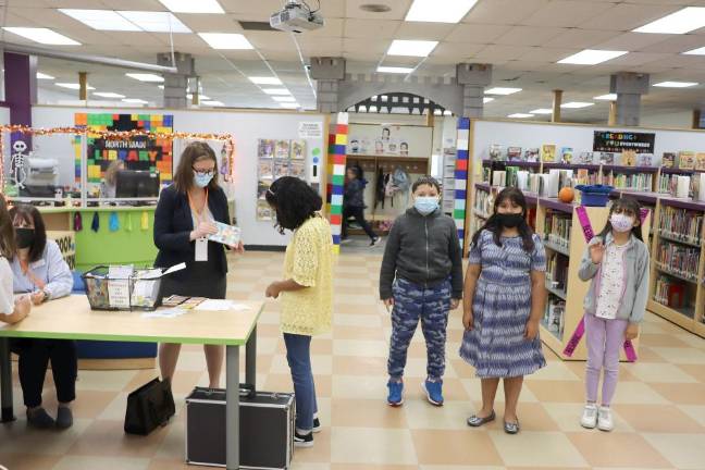 MFL Executive Director Amanda Primiano provides welcome packets to North Main Elementary Students.