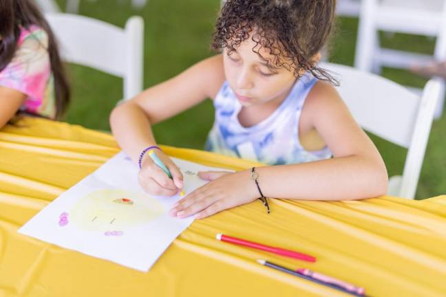 Zoe of Harriman write a get well card at Hope Rocks for Kids, Smith’s Clove Park.