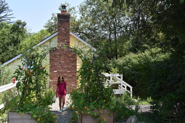 A visitor checks out the Colon-Mariotti garden. This expanded raised bed portion was built over a former driveway. (Photo by Becca Tucker)