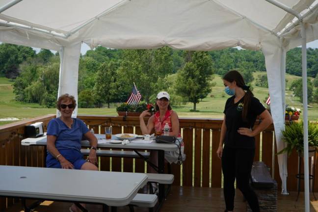 Mary Silva and Patti Ehlers enjoy the view and lunch at Tequila Grill, alongside their server, Angela. They just finished nine holes of golf at Monroe Country Club. Photos by Molly Colgan.