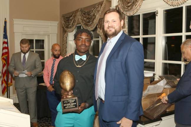 Eryk Shammgod with the Joe S. Puliafico “Most Valuable Offensive Player “Award, stands with Assistant Coach Brent Van De Weert