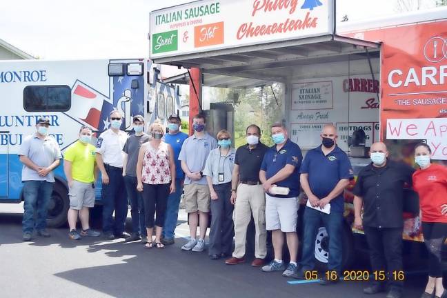 On May 16, The Monroe Town Board and Carrero's Curbside Cafe Food thanked front-line workers with lunch. Pictured are members of the Monroe Town Board and Monroe Volunteer Ambulance. Photo by Wayne Chan.