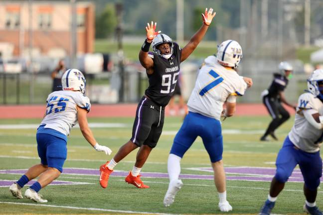 Crusader defensive linemen Tyler St Jean #95 tries to block a Wizard pass.