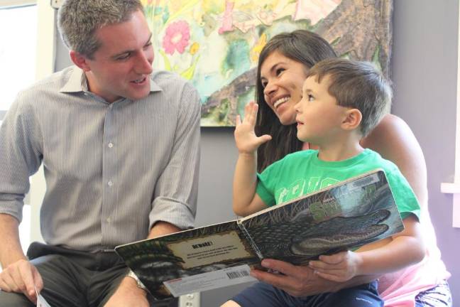 The Rev. Nicole Lesandra and son Joseph (demonstrating he is five years old) learned about the RCLS Road trip by visiting the Monroe Free Library.