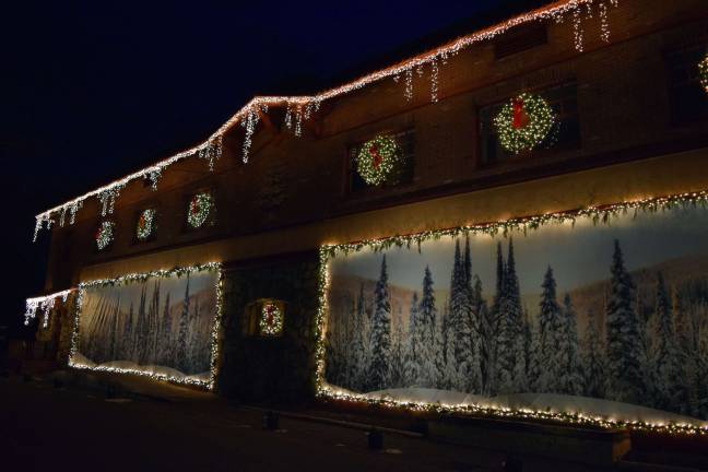 The old Tuxedo IGA building, which will be transformed into the Tuxedo market opening next summer, is decorated for the season with lights, wreaths, and winter scenes.