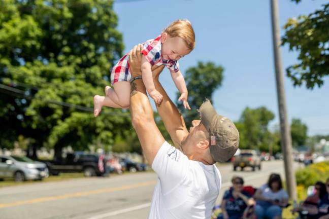 Luke, 11 months, held up by his dad Mr. Landesberg.