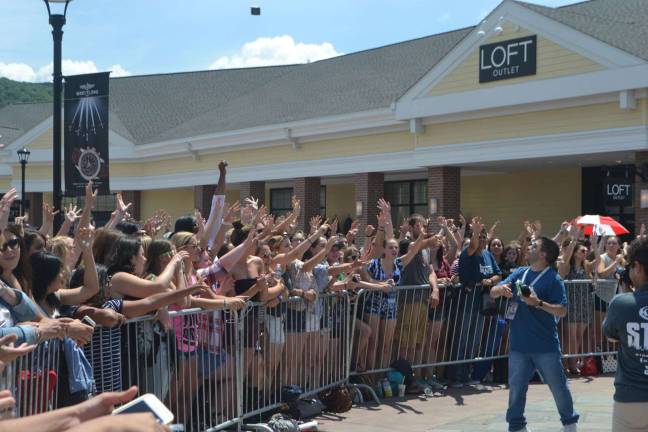 An emcee from K104.7 throws out freebies into the crowd.