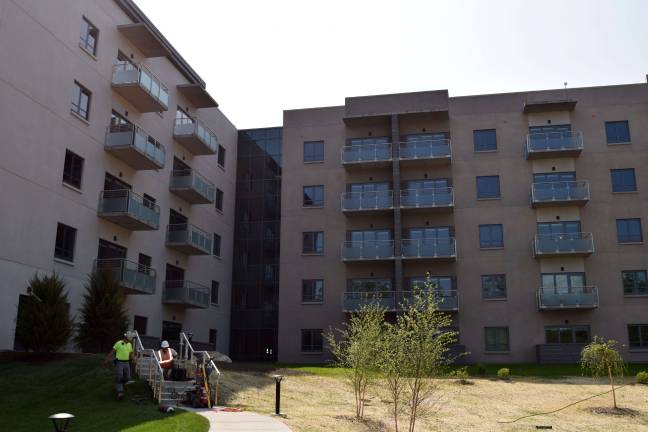 The four residence buildings will house the 800 to 850 Jehovah's Witnesses who will live and work on campus, with room for a maximum of about 1,000.