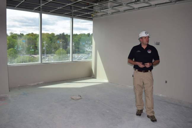 Photo by Erika Norton Orange County County Executive Steve Neuhaus stands in what will be his new office suite in the new county government center.