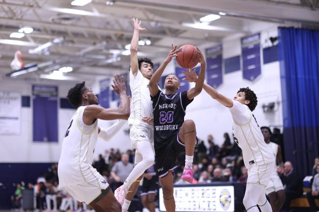 Kristopher Bjaelker, #20, attacks the basket in the second half.