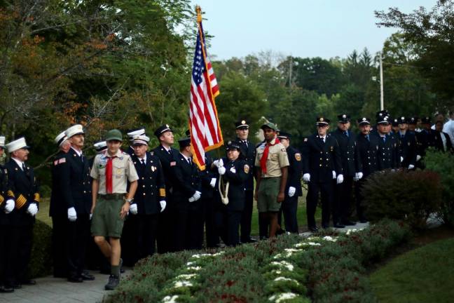 Members of Boy Scout Pack 440 as well as firefighters, police and first-responders take part in the Service of Remembrance.