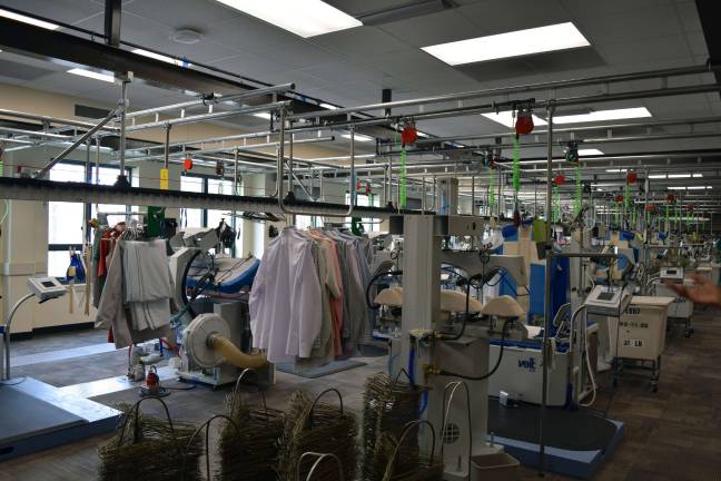 Photo by Erika Norton To wash the clothes and linen of the more than 800 people who live at the headquarters, a complex laundry system run by 40 workers is set up to handle the nine tons of clothing/linen per week. Each garment has a barcode corresponding with each resident, and in the press room, 2000 dress shirts and 800 slacks are pressed every week.