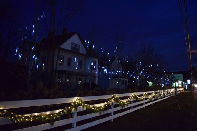 Photos by Erika Norton The Victorian-style houses along Route 17 in Sloatsburg, which will become a hotel, are lit up by the garland along the fence and the dripping blue icicle lights in the trees.