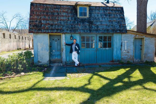 Michael Bruno stands in front of one of the 19th-century barn buildings that will become part of the French Resistance Coffee House &amp; Cafe.