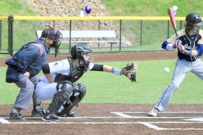 Catcher Timmy Kirpatrick reaches out for a pitch in the first game.