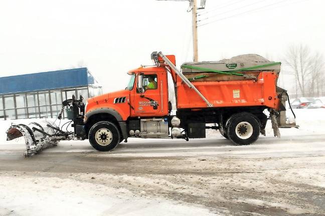 Town of Woodbury Highway Department plows snow on Tuesday morning.