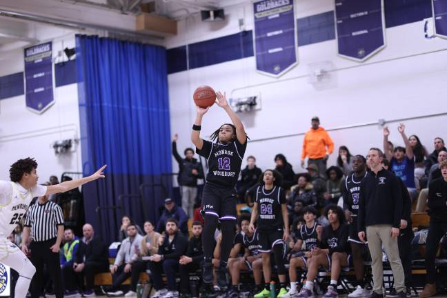 Jamir Johnson, #12, hits a big three-point shot late in the game.