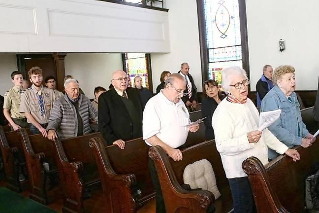 Attendees at the Veterans Day service at the Highland Mills United Methodist Church sing “God Bless America.”