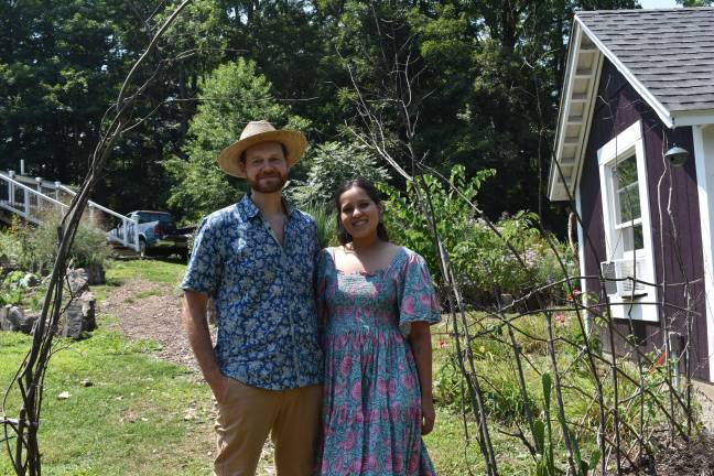 Patrick Scott and Sohan Dhesi took home first place this year for their Florida, N.Y., regenerative ‘tiny farm.’ They’re standing in front of a living fence made of braided dogwood saplings. (Photo by Becca Tucker)