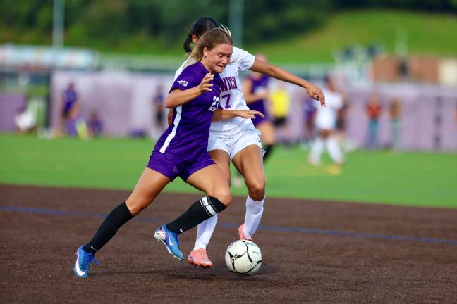 #23 Co Captain Kyra Gilligan muscles her way around her defender.