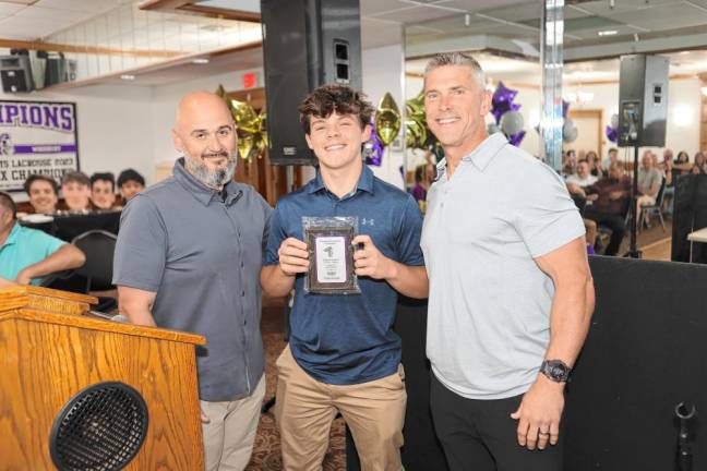 Crusader goalie Tyler Baisley received the Most Improved Player award from coaches Chris Sullivan and Steven Brown.