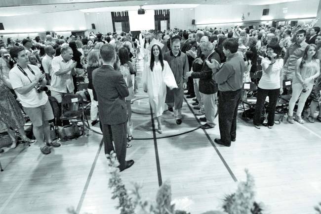 Photo by Ed Bailey Members of the George F. Baker High School Class of 2012 enter the auditorium at the Greenwood Lake Middle School at the start of their graduation exercise. The program was moved from Tuxedo to Greenwood Lake in anticipation of bad weather last Friday evening.