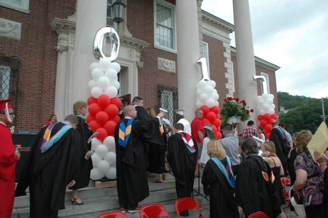 Graduation exercises began outside, but as the skies grew dark, the event was moved inside the high school.