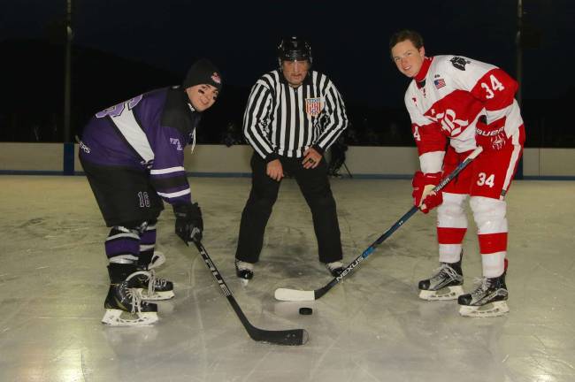 Crusader Joe Baldassarre and Red Raider John Gormley line up for a ceremonial puck drop before the game.