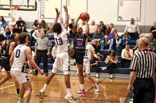 Kristopher Bjaelker, #20, attacks the basket in the fourth quarter.