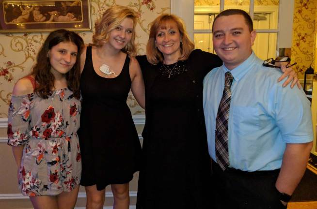 Nancy Peifer, president of the Monroe Volunteer Ambulance and kindergarten teacher, poses for picture with three Monroe Volunteer Ambulance members that were once her students. From left to right are: Karolina Smiechowski, Jillian Backus, Nancy Peifer and Bryan Williams.