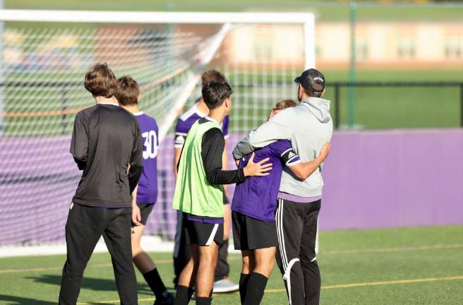 The agony of defeat, head Coach Kenny Clearwater consoles one of his players after the heartbreaking loss.