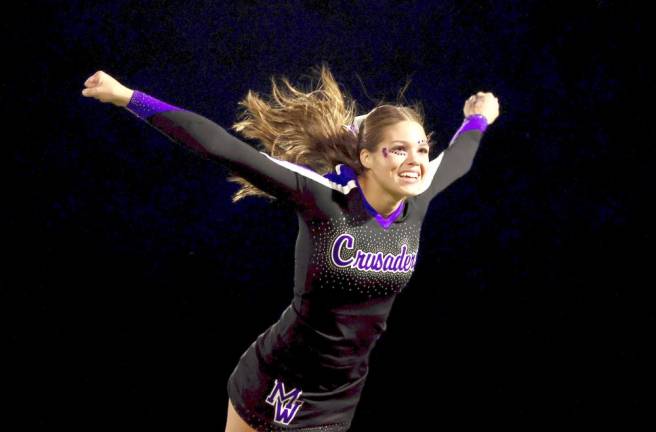 Senior Emily Zrelak fly’s thru the air during the half time show.