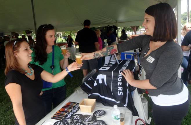 Diana Novak, of Hewitt, and Ellen Fracassini, of Manhattan, enjoy Empire Brewing's White Aphro, poured by Empire's brand manager Olivia Cerio.