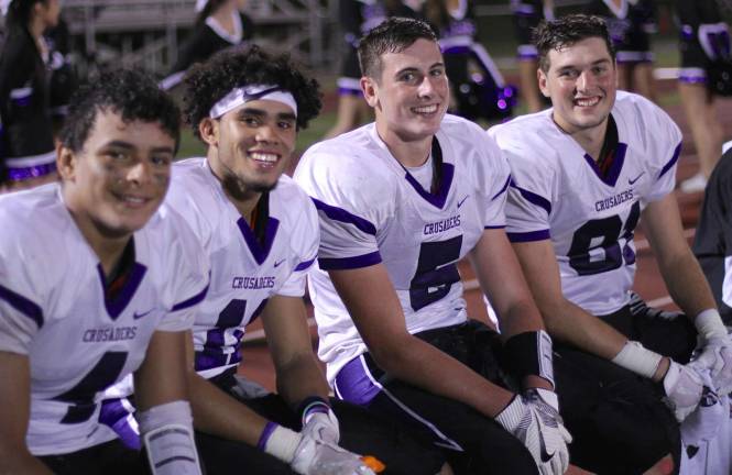 All smiles: Crusaders are all smiles as time runs out. From left to right: Matt Seguinot (#4), Jermain Veras (#11), Jack Colbath (#5) and Garrett Welch (#81).
