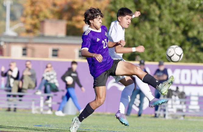 Nicholas Almeida, #23, battles a Goldback defender for the bali P