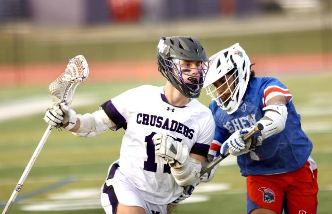 Crusader senior Liam Williamson pushes his way past a Gladiator defender